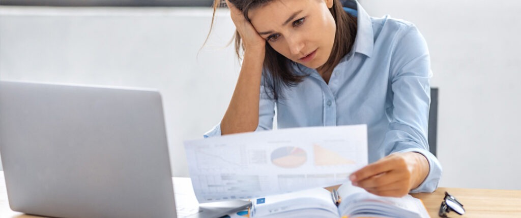 frustrated business woman looking at reports