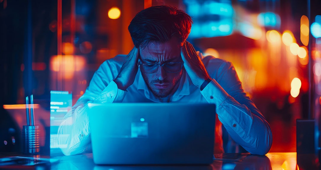 frustrated man looking at computer